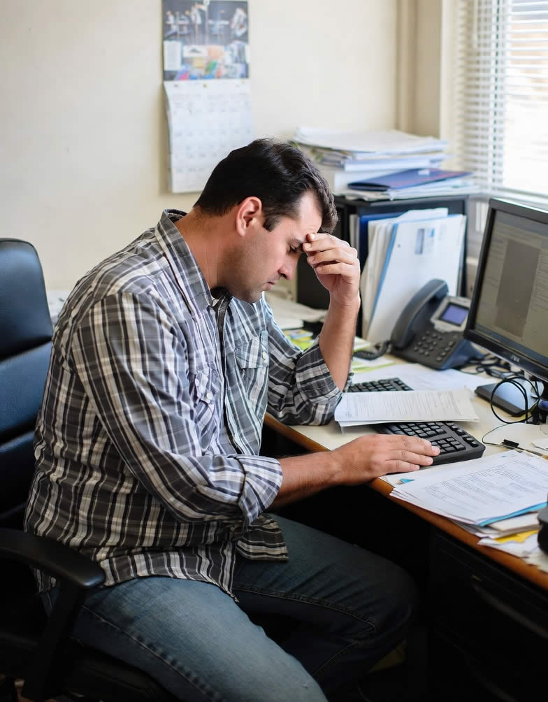 Campbell River contractor sitting at desk with no customer calls — showing how poor web presence hurts trades and local service businesses on Vancouver Island.